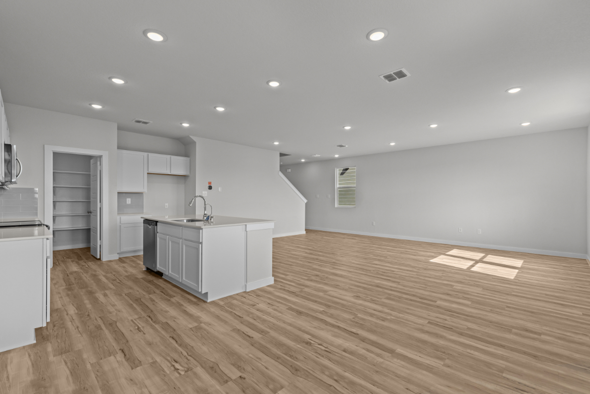 A kitchen with white cabinets.