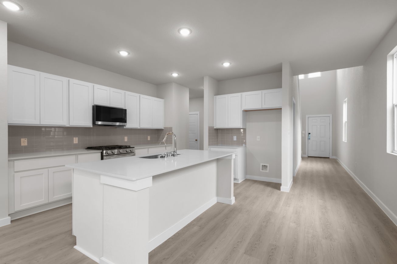 A kitchen with white cabinets.