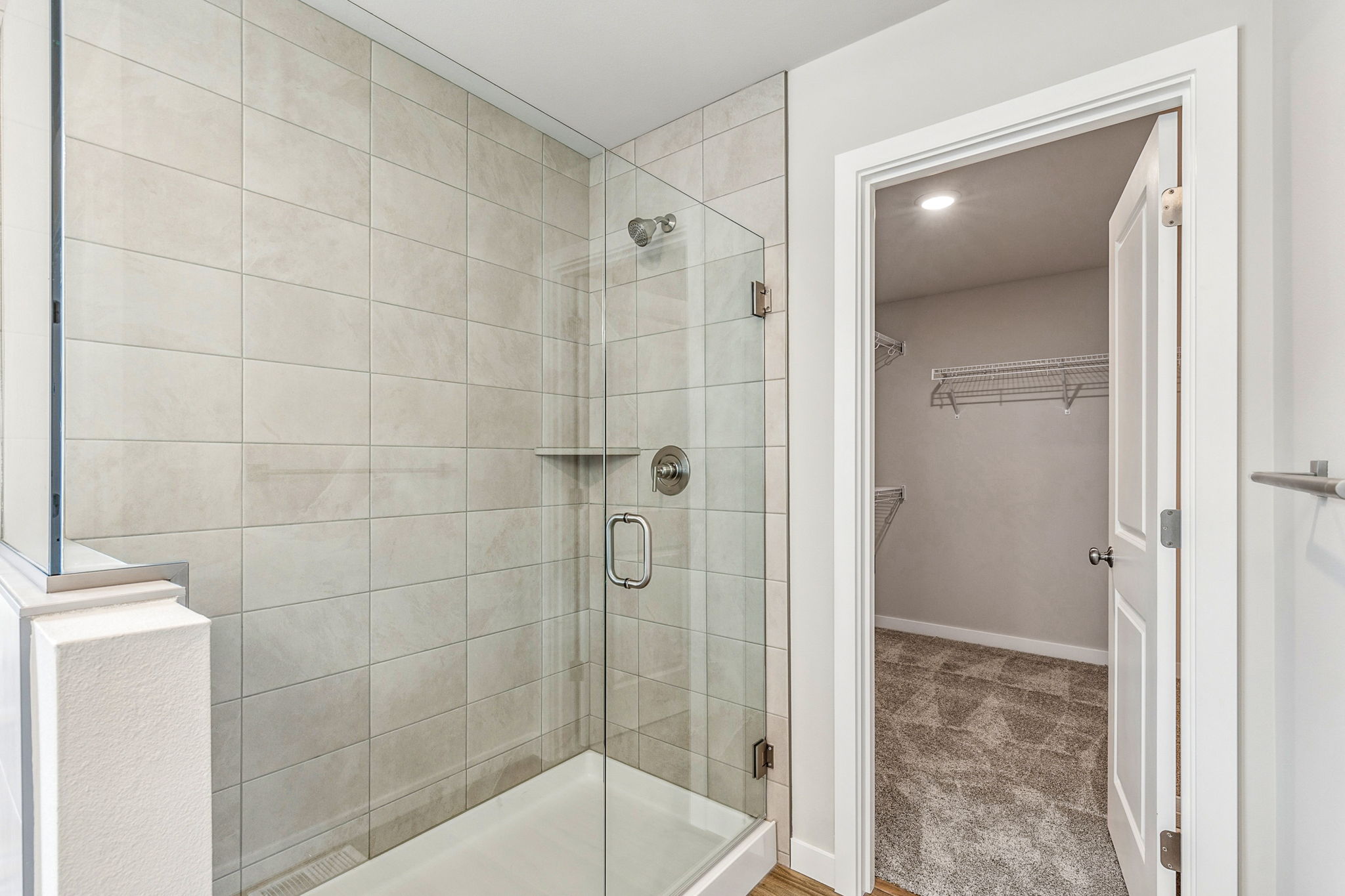 A bathroom with a shower unit and a bathtub.