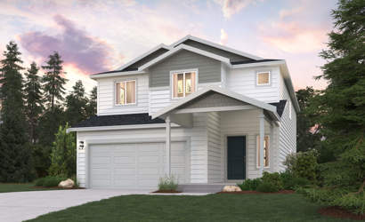 A house with a garage and trees around it.