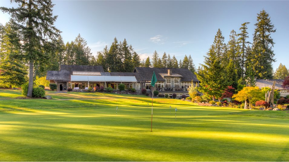 A golf course with a building in the background.