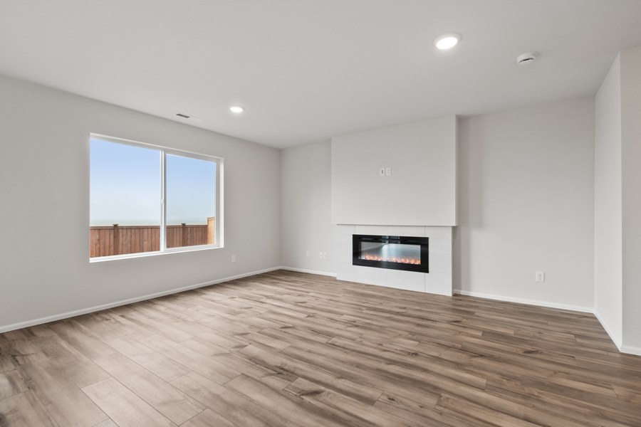 A room with a fireplace and a wood floor.