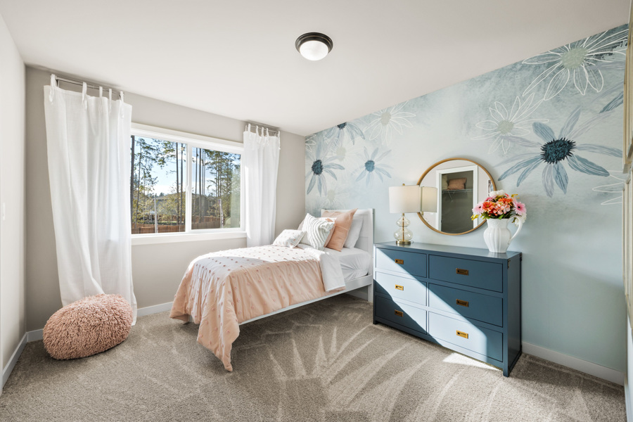 A bedroom with a bed and a dresser.