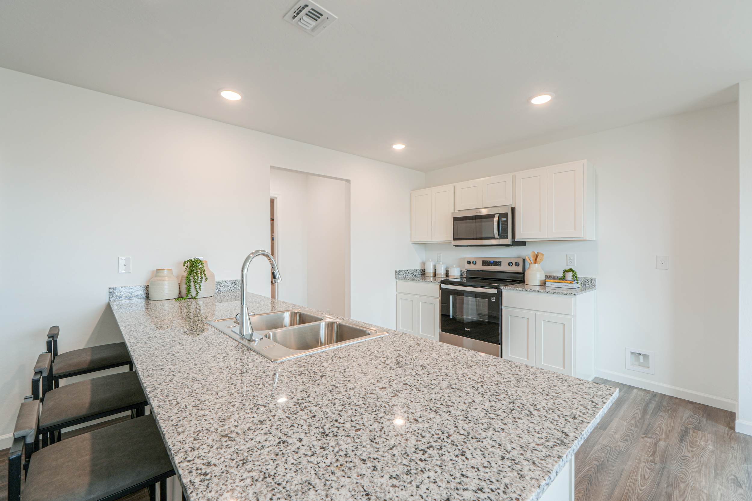 A kitchen with marble counters.