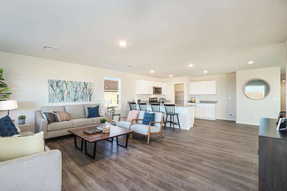 A large living room with a wood floor.