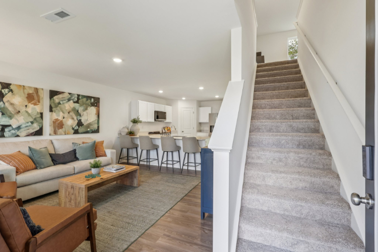 A living room with a staircase.