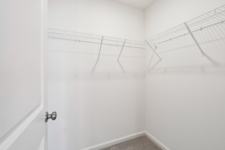 A shower with a metal bar.