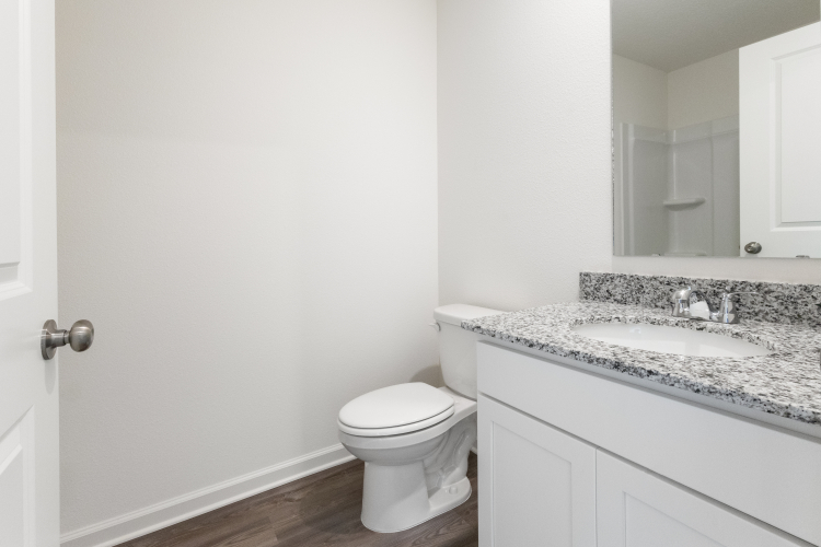A bathroom with a marble countertop.