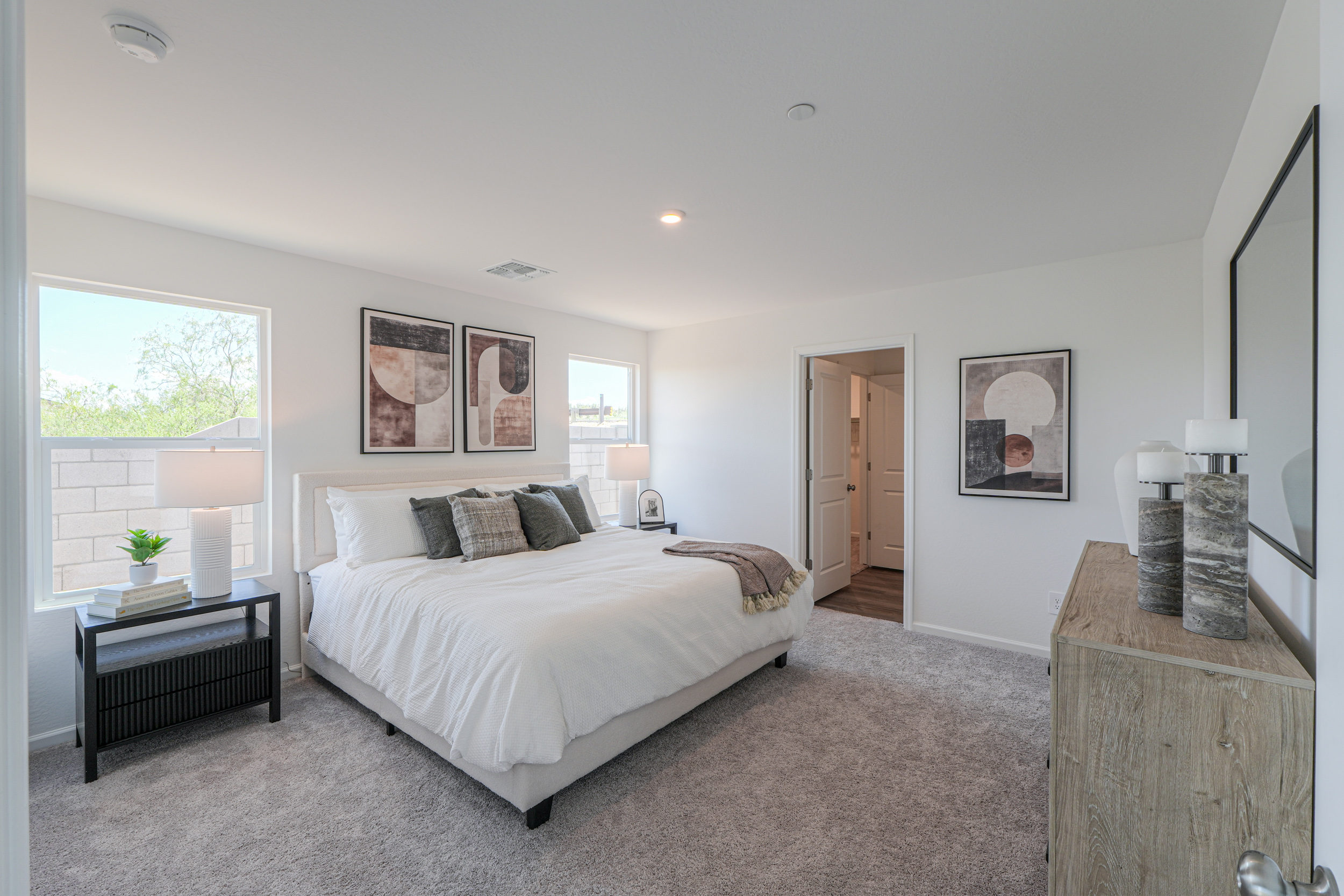 A bedroom with a bed and a table.