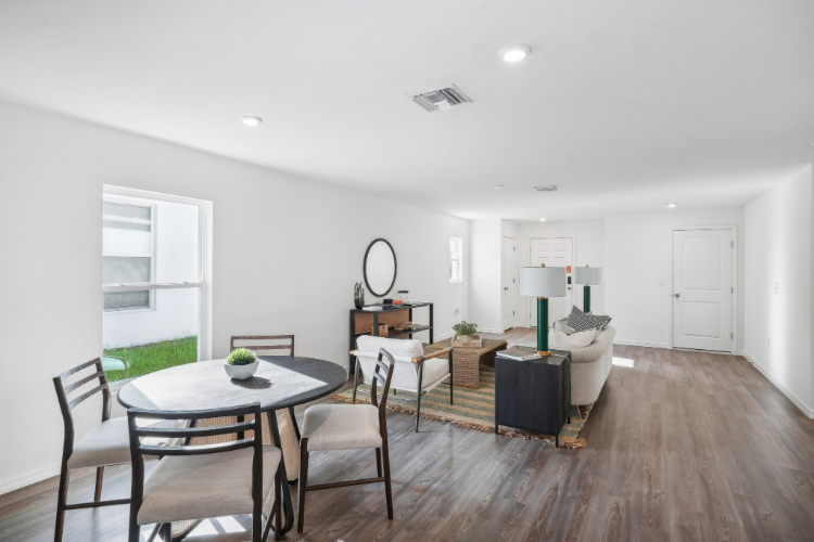 A room with a table and chairs.