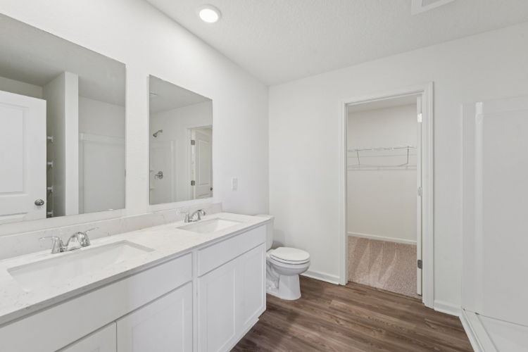 A bathroom with a toilet and sink.