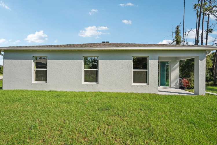 A house with a grass yard.