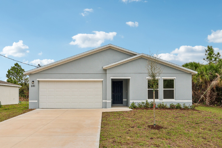 A white house with a garage.