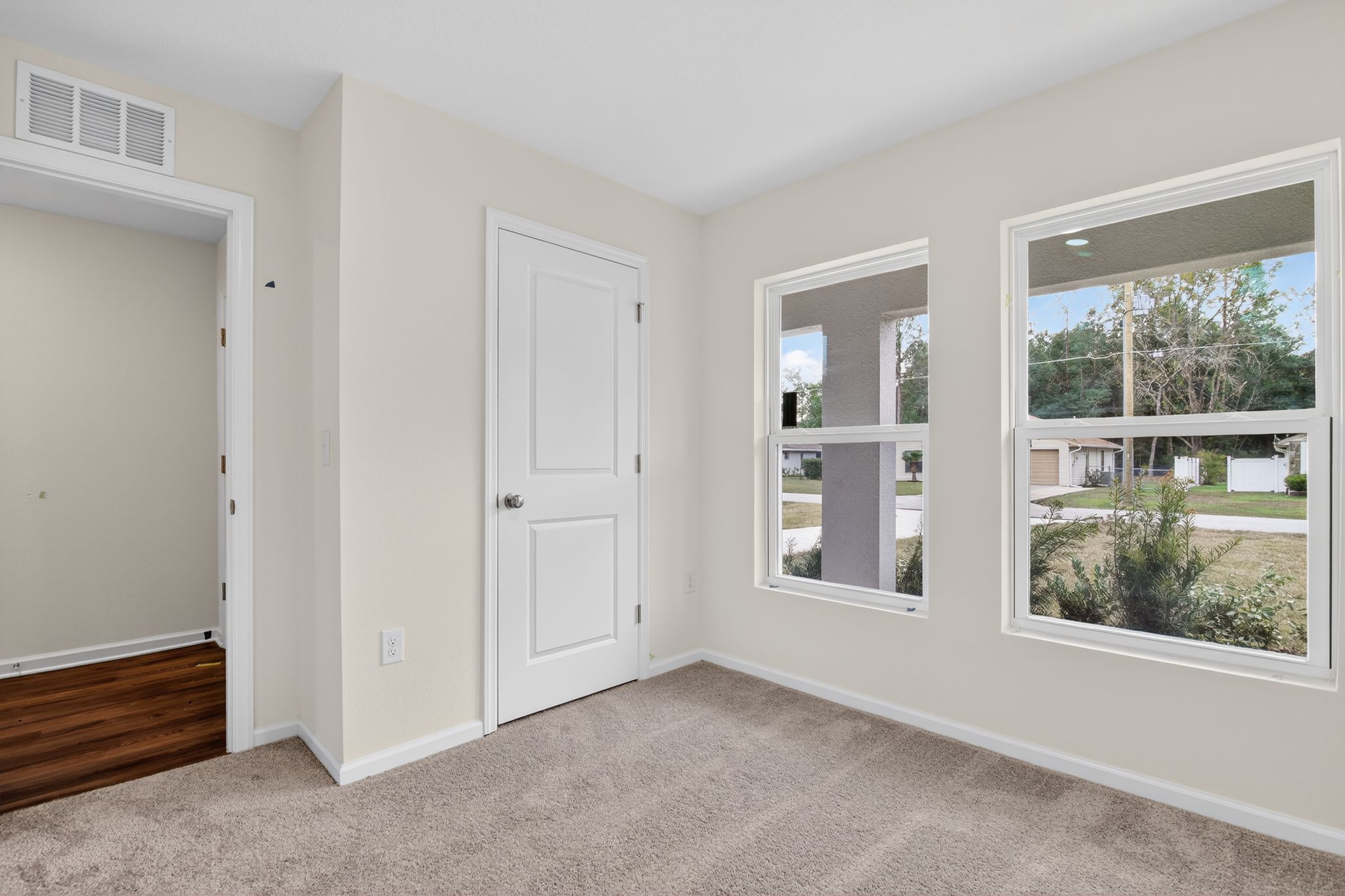 A room with a door and windows.