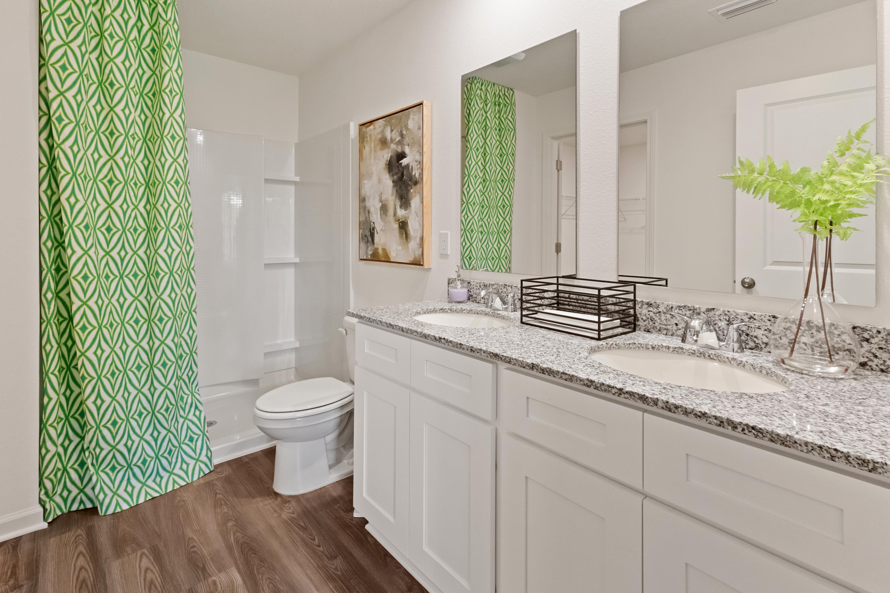 A bathroom with a large mirror.