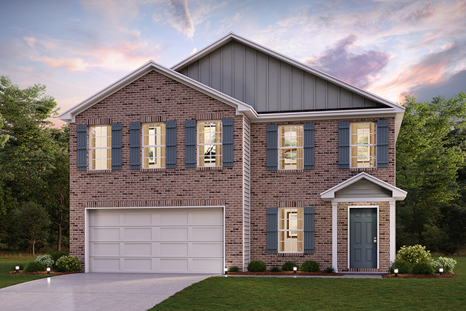 A brick house with a garage.