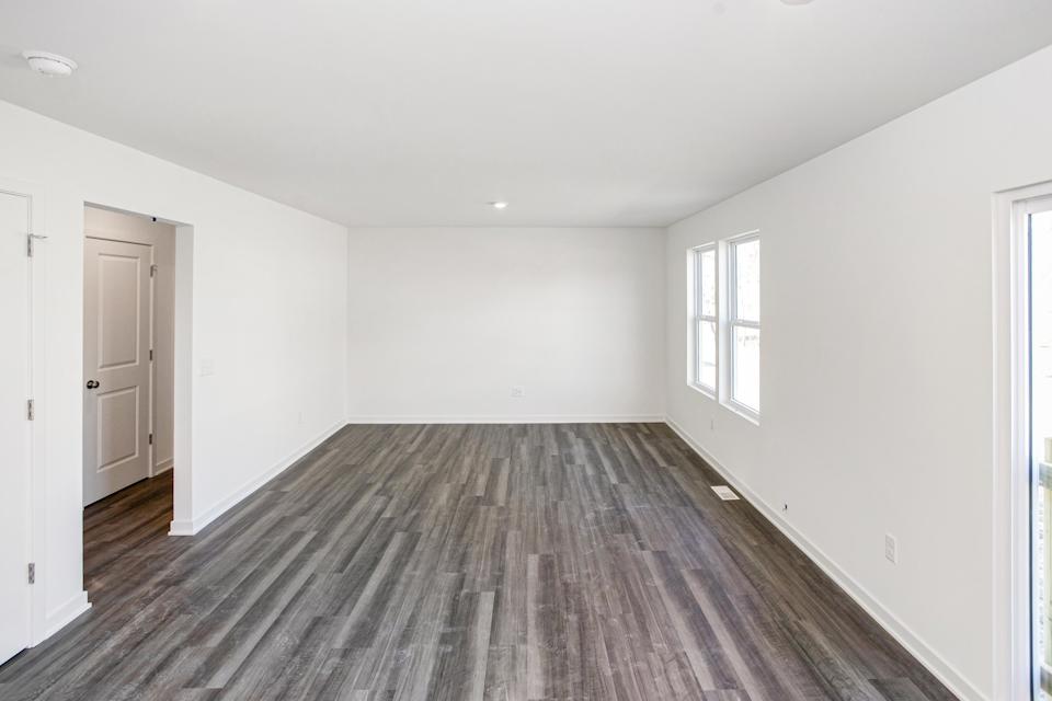 A room with a wood floor and white walls.