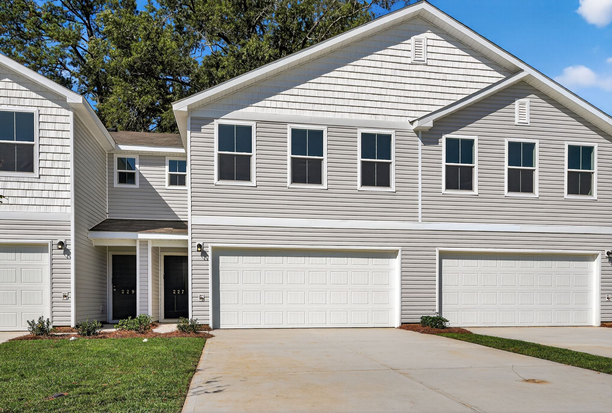 A white house with garages with Ronald Reagan Boyhood Home in the background.
