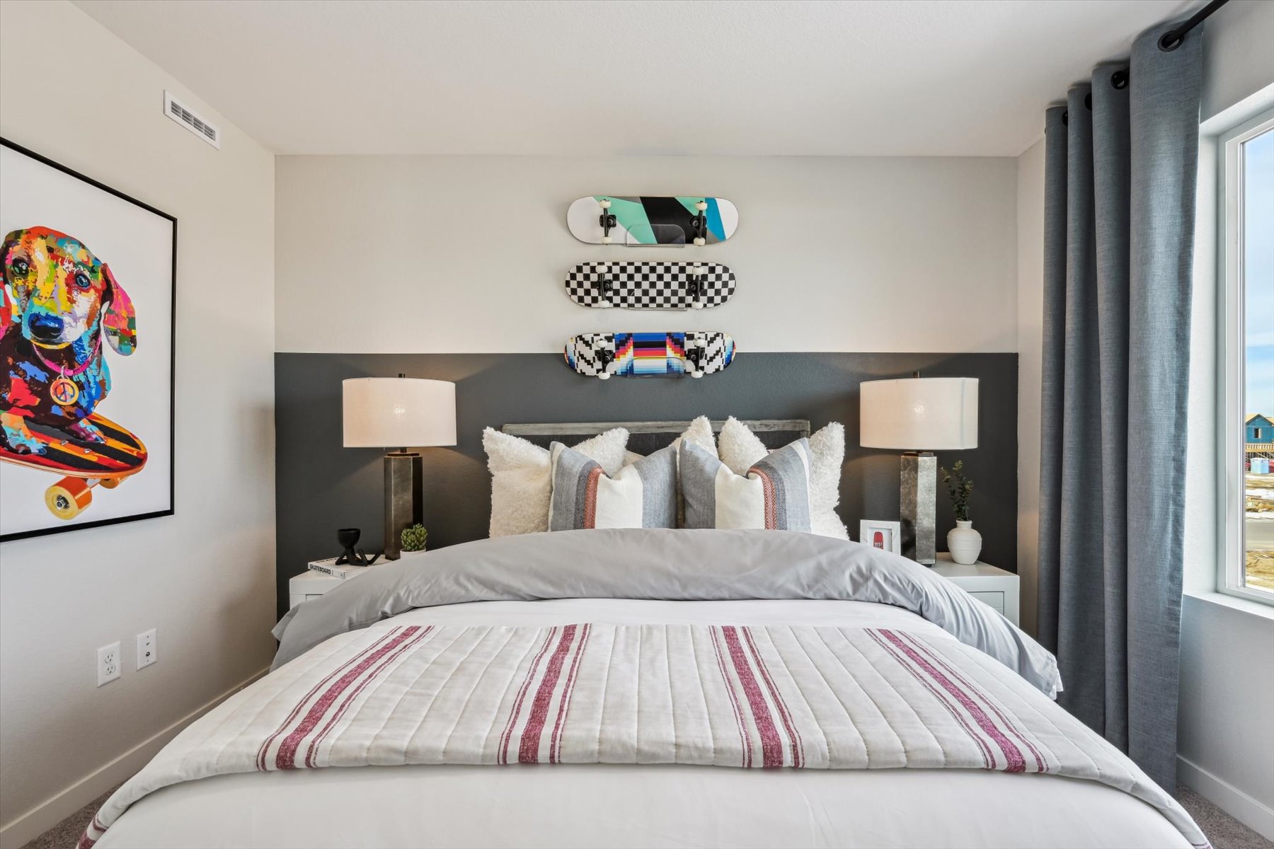 A bed with a striped blanket.